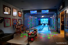 the bowling alley is decorated with colorful lights and pictures on the walls, along with bowling balls