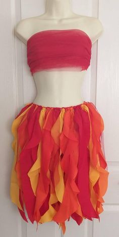 a mannequin wearing a red top and orange ruffles on it's skirt