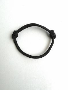 Rope bangle bracelet, Black paracord, 5mm Climbing rope, Minimalist gift, Simple Cord Bracelet, Mens stack Bracelet, Adjustable Bracelet This is a bracelet from 5mm paracord rope. - 100% handmade - Made out of real Paracord 4mm thick - One size fits all due to adjustable knots - The bracelet will wrap only once around your wrist. This bracelet is a great idea to extend your accessories to match as many outfits as possible!! Durable Black Paracord Bracelets, Adjustable Black Braided Bracelet, Adjustable Black Bracelets For Outdoor, Adjustable Black Braided Bracelet For Outdoor, Casual Black Braided Bracelets For Outdoor, Casual Nylon Cord Bracelets For Outdoor, Adjustable Casual Bracelet For Outdoor Activities, Casual Adjustable Bracelets For Outdoor Activities, Casual Adjustable Bracelets For Outdoor Wear