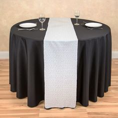 the table is set with black and white linens