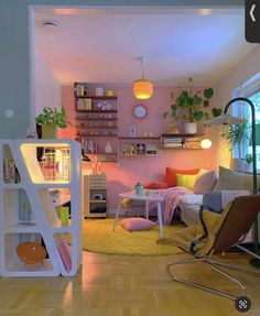 a living room filled with lots of furniture and decor on top of a hard wood floor