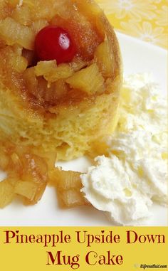 a pineapple upside down mug cake with whipped cream and a cherry on top, sitting on a white plate