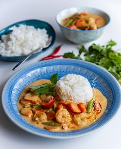 a blue plate topped with rice and shrimp