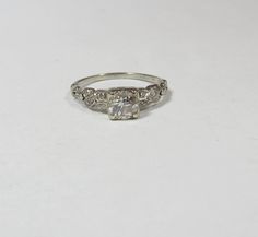 I love this ring and should retail around three times the price I am selling it at. It is marked 18k and solid white gold. The ring weighs 1.8 grams. Set at the top is a round European cut natural diamond . It measures 5.4 mm in diameter which makes it approx .60 cts. The diamond is eye clean and I in color. There are 12 round single cut natural diamonds on the sides with an approx total weight of ..06 cts. The ring wears to a size 6 1/2 and can be resized by your local jeweler.  Always check ou White Band, White Gold Ring, White Gold Rings, Rings Statement, Gold Ring, Natural Diamonds, Statement Rings, Gold Rings, Original Art