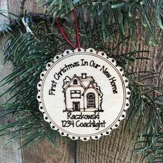 a christmas ornament hanging from a tree on a wooden surface with pine needles