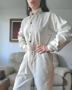 1940s soft cotton coveralls with five pockets. Each cuff has a donut button closure. There are 4 donut buttons on the front with two concealed on the lower half (originally there were 4 but two are missing. Does not affect the wearability or appearance as it's concealed). There are paint and rust and other stains throughout, so evenly done that it makes a beautiful pattern! there are also two small holes on the back left on the upper sleeve and back. Please consult all photos. (Shown on a small Cotton Jumpsuits And Rompers With Buttons, Utility Cotton Overalls With Buttons, Long Sleeve Cotton Overalls With Buttons, Cotton Overalls With Sleeves And Buttons, Utility Cotton Button-up Jumpsuits And Rompers, Cotton Utility Button-up Jumpsuits And Rompers, Cotton Button-up Utility Jumpsuits And Rompers, Vintage Overalls With Relaxed Fit For Workwear, Vintage Relaxed Fit Overalls For Workwear