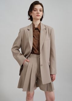 Color: Beige Midweight woven fabric Regular fit Pleated front detailing Side seam pockets Back flap pockets Belt loops Zip fly Hook and bar closure Unlined 60% Cotton 40% Polyester Dry Clean By The Frankie Shop. Imported Beige Clothing, Paris Store, Denim Suit, Classic Trousers, The Frankie Shop, Blazer Beige, Frankie Shop, Paris Woman, Mini Short