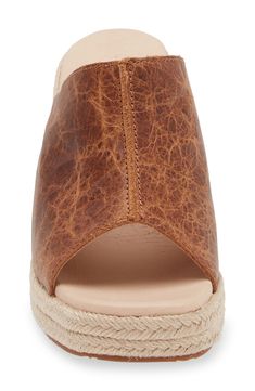 A distressed leather upper creates a lived-in aesthetic on an espadrille-inspired slide sandal lifted by a jute-wrapped platform and wedge heel. 3" heel; 3/4" platform Cushioned footbed Leather upper and lining/rubber sole Imported Chic Natural Leather Wedge Sandals, Brown Wedge Sandals With Textured Sole For Vacation, Brown Textured Sole Wedge Sandals For Vacation, Leather Wedge Sandals With Woven Sole And Open Heel, Brown Espadrilles With Cork-bed Midsoles For Vacation, Leather Open Toe Wedge Sandals With Woven Sole, Casual Leather Wedge Sandals With Textured Sole, Brown Espadrilles With Textured Sole, Natural Leather Wedge Sandals With Woven Sole