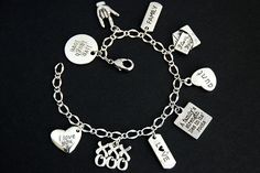 "A collection of silver plated aunt, love, and family themed charms have been dispersed around a shimmering silver plated bracelet chain in this handmade charm bracelet. This aunt themed charm bracelet is then completed with a lobster clasp and a 1/2 inch of chain at the end for adjustable sizing. Charms in this bracelet include a \"live laugh love\" charm, an ASL \"I love you\" charm, a \"family\" tab charm, an \"I love you\" letter charm, an \"aunt\" heart charm, \"A family's strength lies in Personalized Silver Alloy Jewelry, Valentine's Day Silver Charm Bracelet For Friendship, Silver Bracelet With Dangling Charms For Valentine's Day, Charm Bracelet Alloy As Gift, Silver Bracelets With Dangling Charms For Anniversary, Alloy Charm Bracelet Gift, Alloy Charm Bracelet As Gift, Sterling Silver Charm Bracelet For Friendship On Mother's Day, Mother's Day Sterling Silver Friendship Charm Bracelet