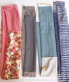 five pairs of women's leggings laid out on a white table top