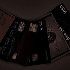 four credit cards stacked on top of each other