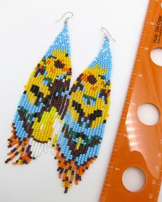 "Native American Style Desert Spring Blossoms great spring colors in a Seed Bead Earrings Handmade Ethnic Earrings Stainless Steel Ear Wires Free Shipping. Handmade beautiful brick weave Native American Ethnic Style earrings in great colors. Earrings hang about 6\" off the ear and are good for many face and neck sizes. Stainless steel ear wires for your safety. Free Shipping from Hawaii with Aloha!" Southwestern Round Beads Earrings For Beach, Southwestern Style Earrings For Summer Festival, Multicolor Beaded Flower Earrings For Festivals, Artisan Multicolor Earrings For Summer, Southwestern Multicolor Round Bead Earrings, Adjustable Multicolor Flower Earrings With Colorful Beads, Beaded Multicolor Flower Earrings For Summer, Multicolor Beaded Drop Flower Earrings, Multicolor Beaded Flower Drop Earrings