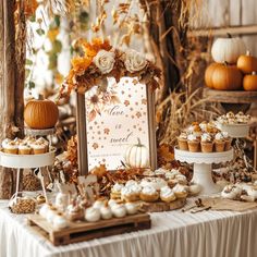 a table topped with cupcakes covered in frosting