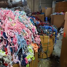 a pile of clothes sitting on top of cardboard boxes