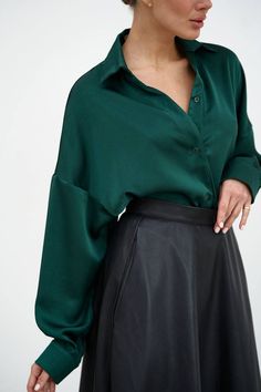 "Elegant green emerald satin shirt will accentuate your stylish look!  The straight collar, dropped shoulder line and asymmetrical hem of the shirt make it interesting, fastened with buttons.  The shirt can be worn in different variations, on the inside and out, tie the front edges of the shirt with a knot, the shirt goes well with any bottom from a classic style skirt to ripped jeans or leather shorts.  Suitable for casual everyday look, office and work, as well as for special occasions of graduation, birthday or holiday party.   DETAILS  - emerald green  - satin  - asymmetric hem  - straight collar  - dropped shoulder line  - buttoned     SIZES   This shirt is available in 2 sizes S-M and L-XL   Back length 29.52\"/ 75 cm  Dropped sleeve 17.7\"/ 45 cm  Shoulder 12.79\"/ 32.5 cm  S-M BUST Green Satin Button Up Outfit, Emerald Green Style Outfit, Emerald Green Clothes Casual, Emerald Shirt Outfit, Forest Green Shirt Outfit, Emerald Green Outfit Casual, Emerald Green Outfit Aesthetic, Emerald Green Shirt Outfit, Emerald Green Top Outfit