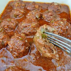 meatballs in sauce with a fork sticking out of it