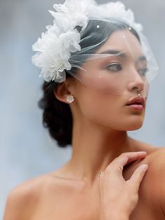 a woman wearing a veil with flowers in her hair