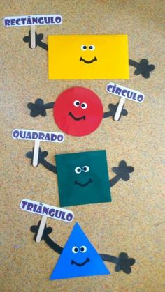 four different colored paper shapes with faces and words written on them, in the shape of three