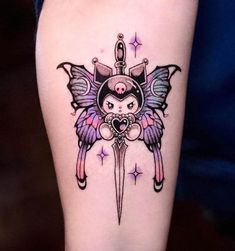 an artistic tattoo design on the leg of a woman's leg with a knife and wings