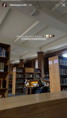 the library is full of books and people are sitting at their desks in front of them