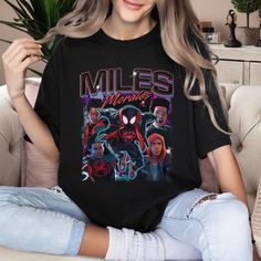 Miles Morales Shirt, Miles Morales Homage T-Shirt, Funny Spider Man Hero Shirt, Black Spider-Man Across Tee, Superhero Birthday Gift LS5298 Welcome to my store! I will help you to have a good shopping experience as much as I can. If you have any request please feel free to message me. I will reply as soon as possible. I have listed some information to help you below: HOW TO ORDER? : Choose the color and size you want. If available, enter the customization information in the text box. Click the Add to Cart button. You can go back and add other items to your cart to buy more. - Decoration type: Digital Print - High material + 100% heavy cotton include styles: Classic T-shirt, Youth T-shirt, Women T-shirt, Unisex Tank Top + 50/50 cotton/poly include styles: Sweatshirt, Hoodie + 100% combed ri Graphic Tee With Crew Neck For Fan Conventions, Crew Neck Top With Front Print For Fan Conventions, Black Graphic Tee For Fan Conventions, Character Print Crew Neck Top For Fan Conventions, Crew Neck Tops With Character Print For Fan Conventions, Black Top With Front Print For Fan Conventions, Black Tops With Front Print For Fan Conventions, Black Pop Culture Top With Sublimation Print, Black Tops With Screen Print For Fan Conventions