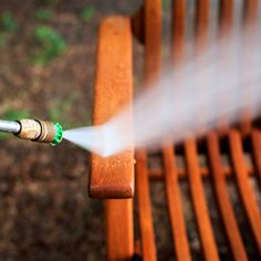 a fire hydrant spraying water onto a wooden bench