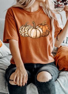 Leopard Print Pumpkins, Leopard Pumpkin Tee, Fall Pumpkin Shirt, Bella Canvas Fall, Gildan Pumpkin Tee, Cozy Fall Sweatshirt, Leopard Print Fall, Pumpkin Apparel, Autumn Pumpkin Tee, Pumpkin Fashion, Fall Lover Shirt, Pumpkin Sweatshirt, Fall Season Tee Welcome to Moose Tales, where comfort meets style! Our exclusive design is printed on the Unisex Garment-Dyed Heavyweight T-Shirt from Comfort Colors 1717, the go-to choice for those who appreciate a structured-fit shirt made from a thick but bre Casual Brown T-shirt For Fall, Cute Brown Crew Neck T-shirt, Brown Graphic Tee For Fall, Trendy Brown T-shirt For Fall, Fall Graphic Tee In Brown, Orange Graphic Tee For Fall, Orange Crew Neck Top For Fall, Cute Short Sleeve Tops For Fall, Brown Graphic Print Shirt For Fall