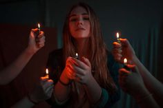 a group of people holding lit candles in their hands