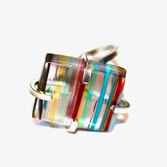 This Surfite ring is simply rainbow perfection! A large Surfite cabochon is prong set in a sterling silver adjustable ring setting. Surfite is made from overspill to the surf board making process. This comes from California and is repurposed and polished into amazing cabochons. This ring is adjustable and best for US ring sizes from 5-10. xoxoxo payton All FizzCandy creations come beautifully boxed and ready for gift giving. Modern Handmade Rainbow Jewelry, Multicolor Sterling Silver Open Ring, Multicolor Open Ring In Sterling Silver, Unique Multicolor Adjustable Rings, Multicolor Polished Rings For Gifts, Multicolor Polished Finish Rings For Gift, Multicolor Polished Rings As A Gift, Multicolor Polished Rings Perfect As Gift, Modern Multicolor Polished Jewelry