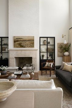 a living room filled with furniture and a fire place in the middle of a room