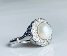 Beautiful fine quality white pearl ring, genuine late art deco era cultured pearl ring from Verona, Italy estate. Made from platinum with halo of 12 sparkling diamonds. There are twelve 2 mm old single cut diamonds, estimated SI1 and G/H with a total diamond carat weight for the ring of approximately .36 carat. Gorgeous art deco elegance in this unique antique design. Ring weighs 4.6 grams. Details: Size 6.5 and can be sized up or down for 45- by adding our custom sizing listing to your cart usi Italian Art Deco, Late Art, White Pearl Ring, Cultured Pearl Ring, Antique Engagement Rings Vintage, Pearl Engagement Ring, Antique Engagement Ring, Verona Italy, Antique Engagement