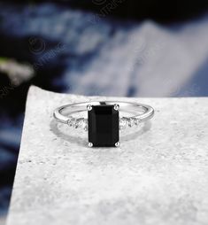 Antique Black Onyx Engagement Ring, Emerald Cut Black Onyx Ring, Black Onyx Ring White Gold, Dainty Diamond Ring, Tiny Moissanite Ring Engagement ring: Main Stone Name: Black onyx Main Stone Size: 8*6mm Main Stone Shape: Emerald Accent Stone Name: Moissanite or diamond Accent Stone Size: 2.0mm/1.3mm/1.0mm Accent Stone Shape: Round Metal: Yellow Gold/Rose Gold/White Gold Metal Purity: 14K/18K * Main stone can be personalized per request and budget. The Ring can be made with Diamonds, Moissanite, Black Emerald Ring For Anniversary, Elegant Black Emerald Promise Ring, Fine Jewelry Black Onyx Diamond Ring, Black Emerald Cut Diamond Promise Ring, Black Emerald Cut Diamond Ring For Promise, Black Emerald Cut Promise Ring, Black Emerald Ring For Promise, Black Band Emerald Ring For Promise, Black Onyx Diamond Ring Gift