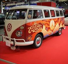 an old vw bus on display at a car show