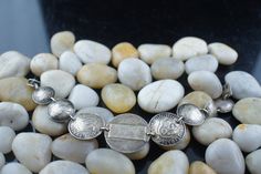 This is the perfect option for those who like cool, unique jewelry and the luxury, shine of silver. The bracelet is made of Australia coins that are linked together. The coins have different size. The middle has been engraved:New.... Gean Brother. The length of the bracelet is about 7.5 inches. The weight is 32g. The age is circa 1940s-1950s. ♥ There is no hallmark, but It is sterling 925(tested with acid). Everyone interested in the jewelry should remember that they must like their bracelet - n Antique Silver Bracelet Gift, Antique Silver Engraved Bracelets, Antique Silver Engraved Bracelets For Anniversary, Silver Stamped Bracelet, Silver Stamped Bracelet Jewelry, Stamped Silver Bracelet Jewelry, Stamped Silver Bracelet, Engraved Antique Silver Bracelets For Anniversary, Vintage Silver Engraved Jewelry