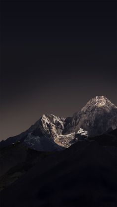 the mountains are covered in snow at night