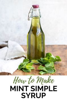 how to make mint simple syrup in a glass bottle on a wooden table with basil leaves