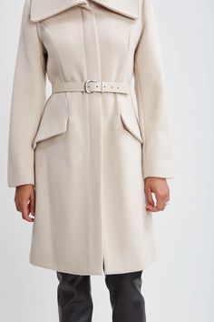 Wrap up this season in our chic belted coat done in a warm double face wool. This sophisticated fully lined coat makes a cold weather statement featuring an oversized collar, contour seams and vegan leather belt; the silhouette is a modern twist on a classic, setting a new standard in outerwear. Elie Tahari Exclusive Panel Wool Coat with Vegan Leather Belt & oversized collar 80% Wool, 15% Nylon, 5% Cashmere Runs true to Size Length From Shoulder to Hem: Back 38.5"L, Sleeve: 33"L (approx. length Timeless Belted Long Sleeve Outerwear, Chic Wool Coat With Belted Cuffs And Lapel Collar, Chic Belted Beige Wool Coat, Chic Long Wool Coat With Self Belt, Chic Belted Wool Coat, Elegant Winter Outerwear With Belt Loops, Formal Winter Outerwear With Self Belt, Elegant Long Coat With Belt Loops, Chic Belted Wool Coat With Lapel Collar