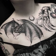 a woman with a tattoo on her chest has a dragon and demon behind her back