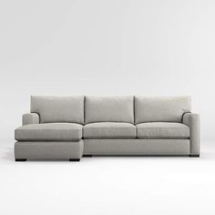 a gray couch sitting on top of a white floor