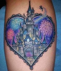 a tattoo with a castle in the shape of a heart and fireworks on it's side