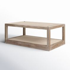 a wooden coffee table sitting on top of a white floor next to an empty shelf