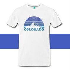 a white t - shirt with the word colorado printed on it and mountains in the background