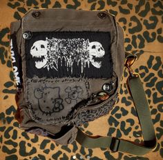 a purse with skulls on it sitting on a leopard print surface