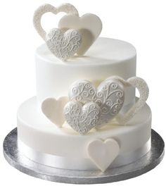 two tiered wedding cake with hearts on the top and bottom, decorated in white frosting