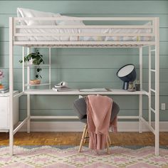 a white bunk bed sitting on top of a wooden floor next to a desk and chair