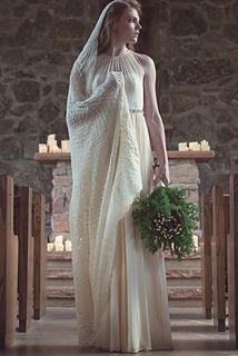 a woman in a wedding dress holding a bouquet