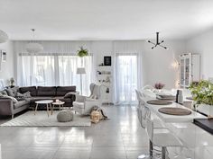 a living room filled with furniture and white walls