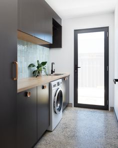 a washer and dryer in a small room with doors leading to the outside