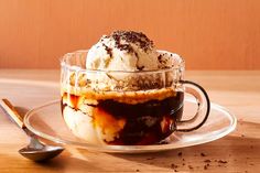 an ice cream sundae in a glass cup on a plate