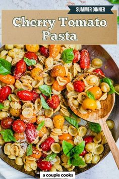 a pan filled with pasta and tomatoes on top of a table